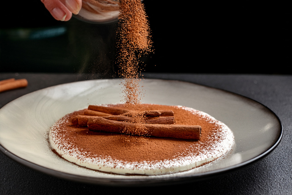 Cinnamon-being-added-to-a-dessert-or-dish