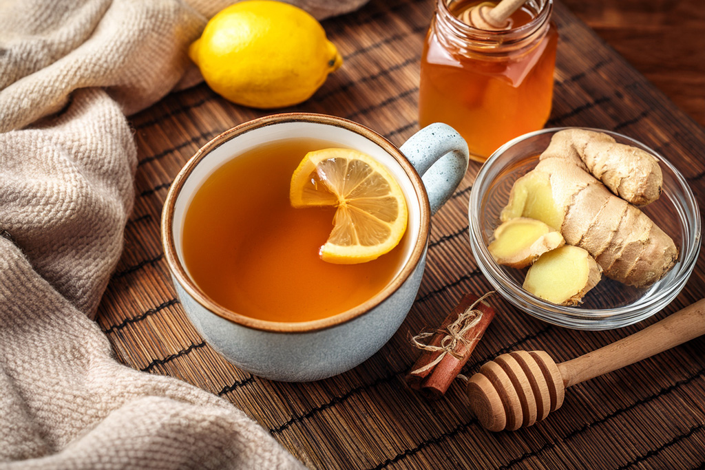 Lifestyle-shot-Ginger-tea-in-a-cozy-mug-with-lemon-and-honey