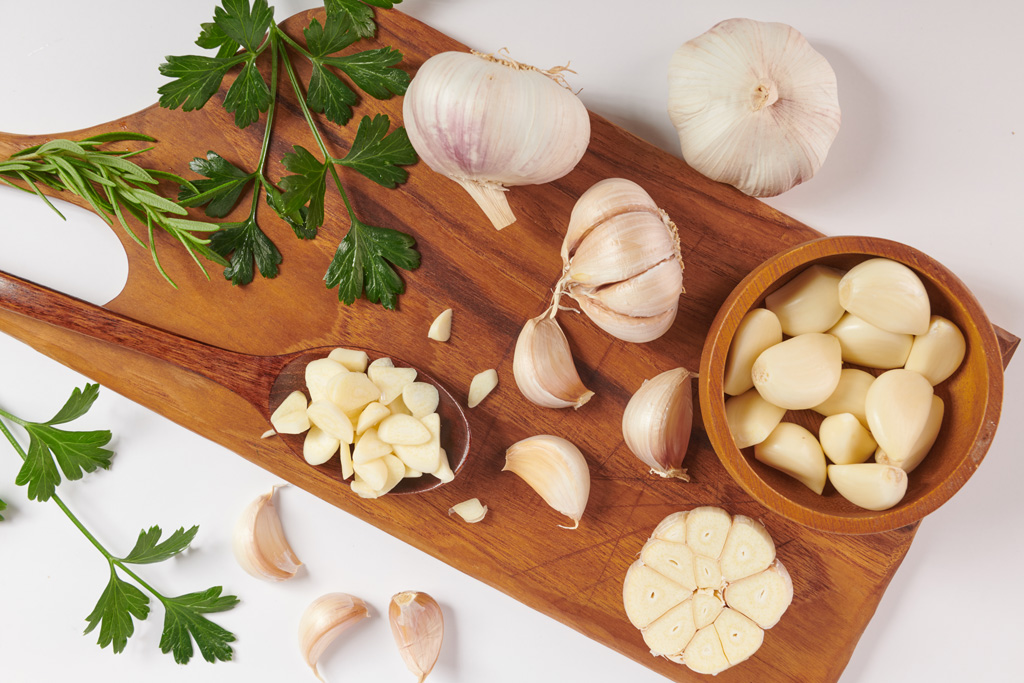 garlic-with-rosemary-parsley-peppercorn-wooden-board-isolated-white-surface-top-view-flat-lay-freshly-picked-from-home-growth-organic-garden-food-concept